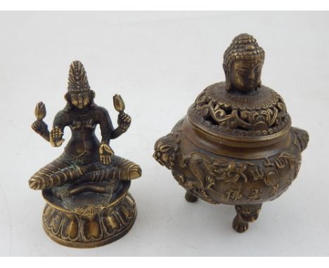An bronze incense burner, the top with Buddha head finial, the body embossed with dragons chasing pearl, raised on three feet