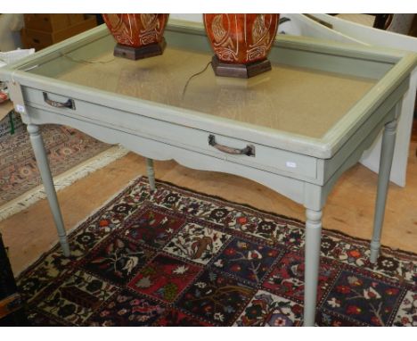 A Victorian style rectangular green painted display table, the glazed top with hessian lined drawer, on turned tapered legs. 