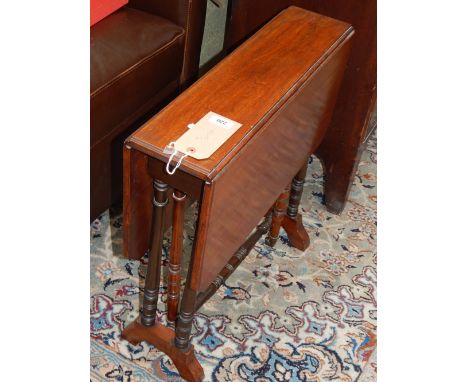 An Edwardian mahogany Sutherland table, the rectangular top with canted corners above twin turned supports, W. 60cm.