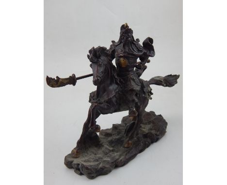 A Chinese bronze figure of a warrior, mounted on horseback, and a stylised base. L: 27cm