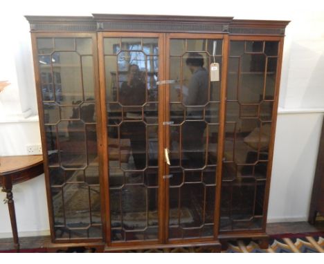 An Edwardian George III design mahogany breakfront dwarf bookcase with fluted Greek key pediment over four astragal glazed do