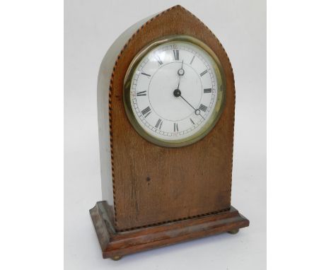 An early 20th century lancet shaped mahogany timepiece, the enamel dial with Roman and Arabic numerals, Breguet hands, the ca