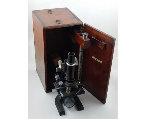 A 20th century microscope by W & J Georgel Ltd., finished in a black crackle lacquer, within a mahogany case, together with a