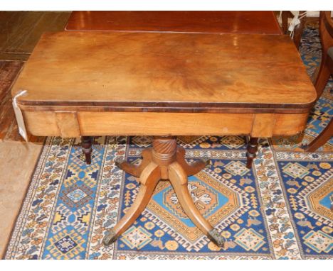 A late George III mahogany card table. the rectangular support above a spiral reeded pedestal support and quadreform base, W.