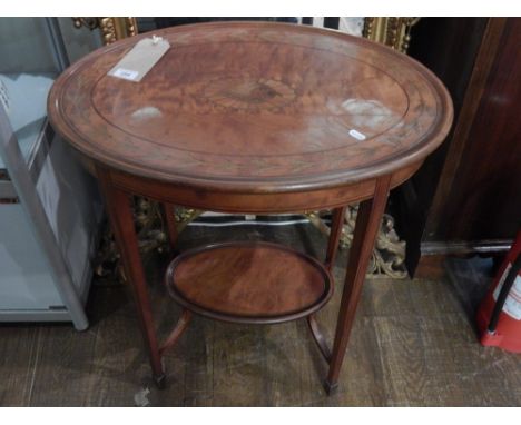 An Edwardian mahogany and inlaid occasional table, the oval top with a foliate motif, on square tapering legs with spade feet