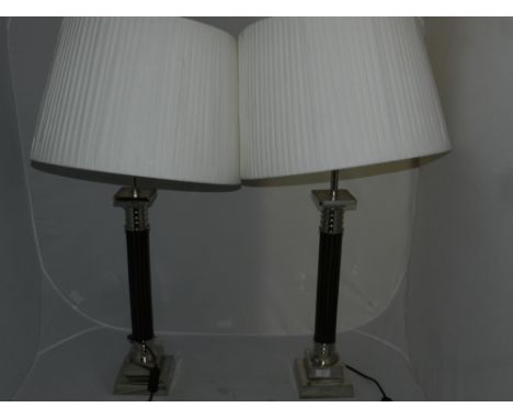 A pair of reproduction Victorian style nickel plated ebonised table lamps with pleated shades H 55 cms