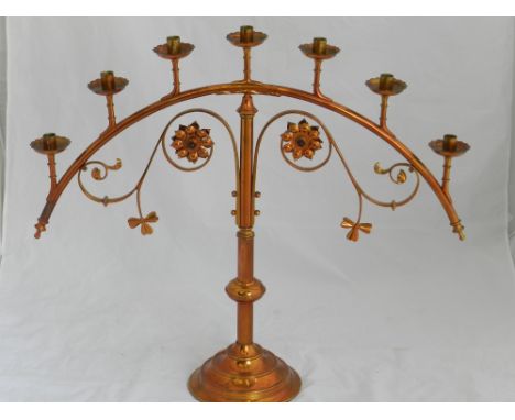 A late Victorian ecclesiastical copper 7 light candle holder with embossed rosette decoration, H:66cm