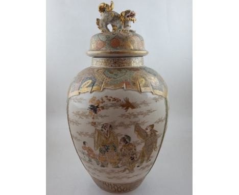 A Japanese Satsuma ware vase  and cover of tapered ovoid form, decorated with scenes of magicians releasing dragons, and stor