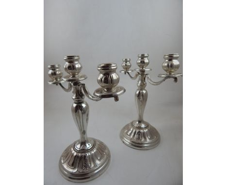 A pair of Continental white metal three light candelabra, fluted baluster stems on raised lobed bases