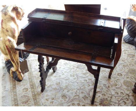 An Italian 17th century and later secretaire table, the rectangular hinged top above a panelled fall and enclosing a drawer, 