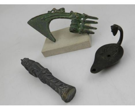 An Egyptian bronze oil lamp, together with a cast iron Shabti and a Chinese green and gilt axe head 