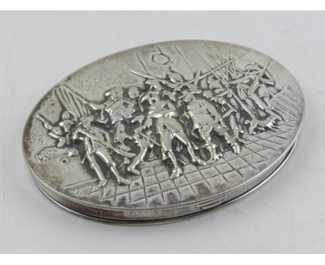 A Dutch oval silver plated compact, the cover embossed with an 18th century battle scene. L. 8cm