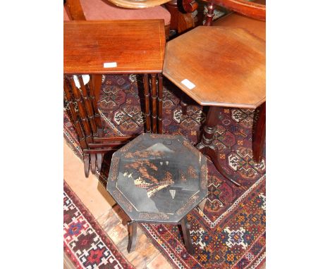 An early 20th century black lacquer table in the Aesthetic taste, the octagonal top decorated with oriental landscape view, W