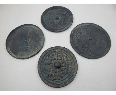 Four various Chinese bronze circular hand mirrors.
