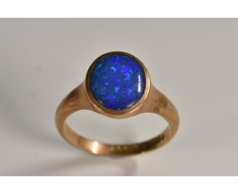 A blue opal signet ring, vibrant oval blue green opaline panel, 9ct rose gold shank, Birmingham 1923, size U, 5.5g gross