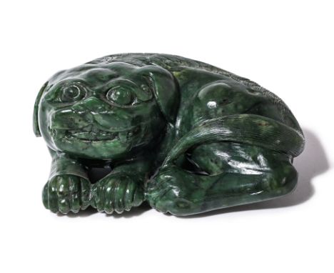 A SPINACH JADE CARVING OF A BUDDHIST LION
Modelled in a recumbent curled pose, it's head resting on its legs,
13cm wide
Condi