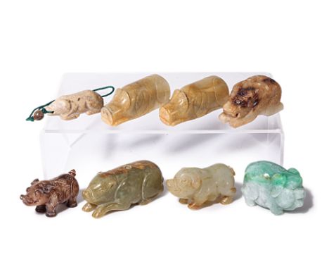 A GROUP OF JADE CARVINGS OF PIGS
Including a yellow-green example with russet inclusion, modelled recumbent with central hole