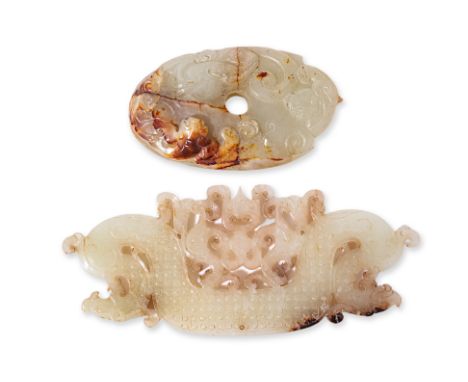 TWO CARVED JADE PLAQUES
The first, of archaistic form carved and pierced with stylised dragons and scrolls; the other example