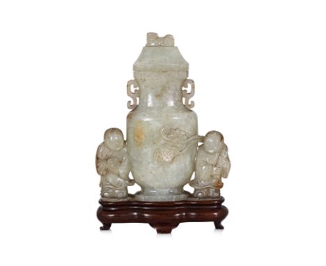 A JADE VASE AND COVER The flattened oval vase with twin archaistic scroll handles, flanked by figures, one holding a lotus, w
