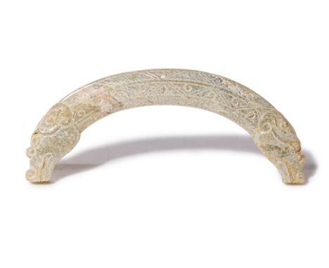 AN ARCHAISTIC JADE DRAGON PENDANT
Of curved form, each end carved with a dragon's head
10.5cm wide
Condition: For a condition