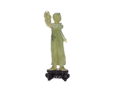 A CARVED JADE CULTURAL REVOLUTION FIGURE
Chinese, 20th Century, a figure of young lady standing holding a lantern aloft, with