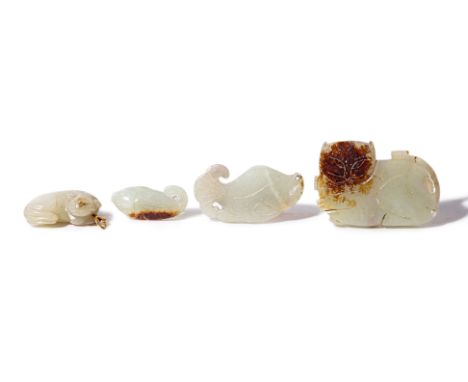 A GROUP OF FOUR CELADON JADE PENDANTS Comprising a recumbent lion with gold coloured bail; two fish; and a cat The cat 6cm wi
