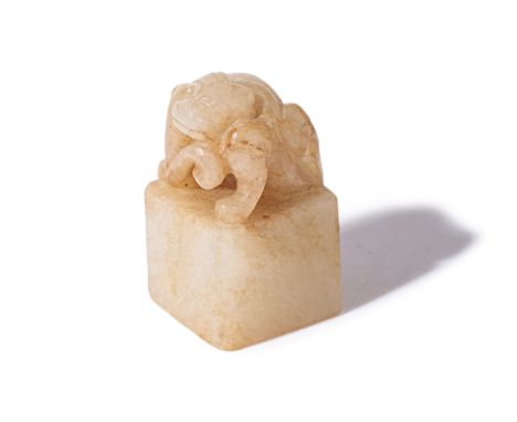 A CARVED JADE CHILONG SEAL Square with carved and pierced coiled chilong, base uncut 3.5cm high Condition: For a condition re