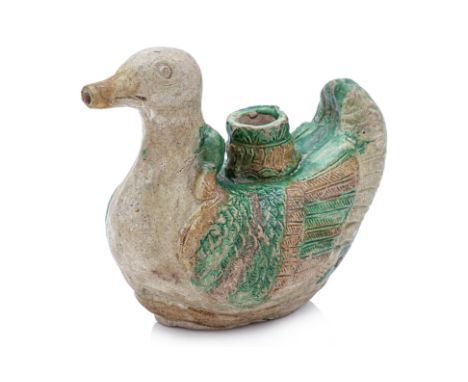 A SANCAI MANDARIN DUCK FORM EWER
Ming Dynasty or earlier, modelled as a pair of conjoined ducks, one with its head lying acro
