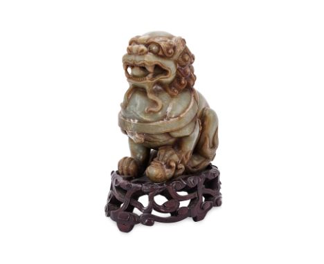 A LARGE CARVED JADE FOO LION AND CUB
Carved in the form of a foo lion standing sejant with a small lion cub under the paw, wi