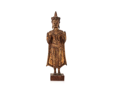 A THAI GILT BRONZE STANDING BUDDHA
Circa 19th Century or earlier, modelled with arms up and palms facing forward, robe hangin