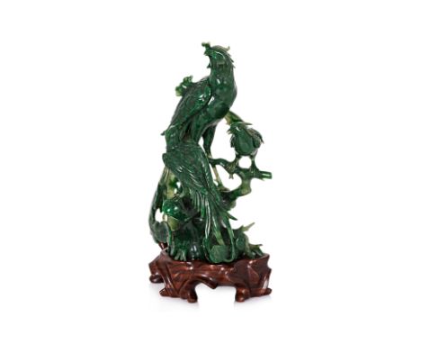 A JADE CARVING OF A PHOENIX AND OTHER BIRDS
Carved with three birds perched on a branch, wood stand

Provenance:
Mr & Mrs R.K