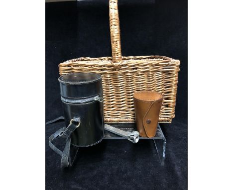 A leather cased triple hip flask and beaker set; a wicker wine carrier for six bottles; a steel cigar cutter; a leather cased