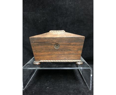 A Rosewood sarcophagus form tea caddy, egg and dart carved details, on four flat bun feet, 21cm max 