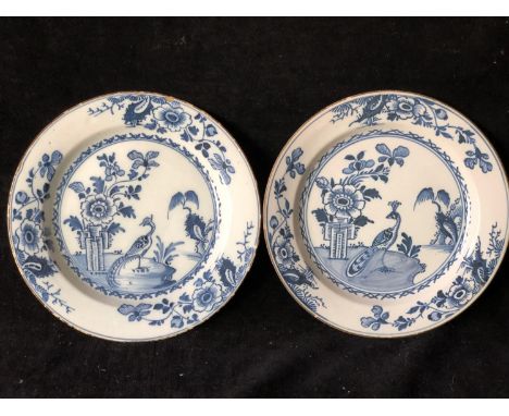 Two english Delftware plates, painted in blue with pheasant and peony pattern, chocolate brown line rims, 23cm diam approx (2
