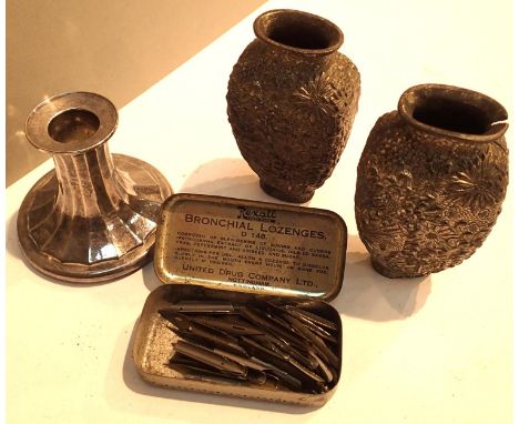 Two Repousse metalware vases, a single Viners silver plated candlestick and a tin containing gold plated and other pen nibs. 