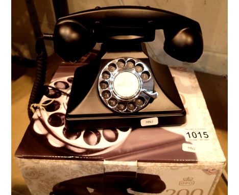The GPO 200 rotary telephone has a metal base and handset; traditional cloth handset curly cord &amp; is compatible with stan