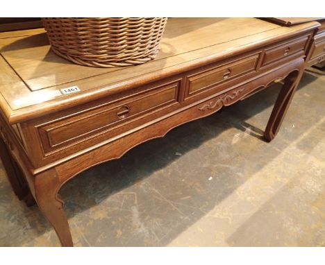 A contemporary three drawer console table in Oriental hardwood with carved hand pulls, 152 x 52 x 84 cm H. Not available for 
