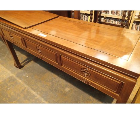 A contemporary three drawer console table in Oriental hardwood with carved hand pulls, 153 x 52 x 84 cm H. Not available for 