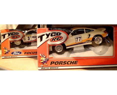 Boxed Tyco RC Mattel wheels remote controlled Ford Focus and a Tyco RC Mattel wheels racing remote controlled Ford Focus. Not