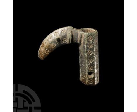 Circa 6th-7th century A.D. Comprising an octagonal tube with tinned finish decorated with ring-and-dot motifs, at the top a h