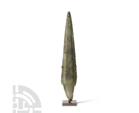 2nd millennium B.C. With narrow pointed blade and wide raised flange down centre, straight sides, well marked shoulders with 