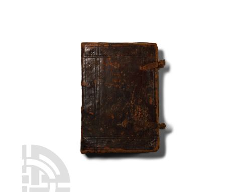 18th-19th century A.D. Leather-bound book of a religious treatise with Naskh text in red on the first page beneath a banner w
