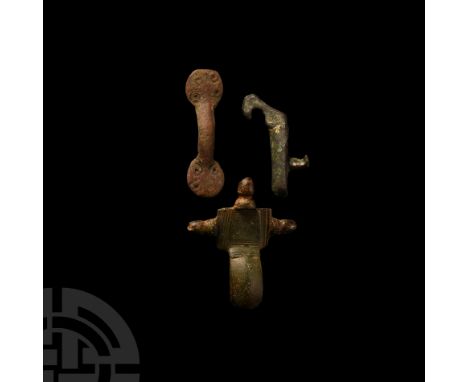 7th-9th century A.D. Comprising an equal-arm brooch with punched ring-and-dot motifs to both terminals; remains of a crucifor