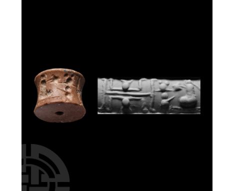 Circa 3rd millennium B.C. Cotton-reel type with drilled frieze of serpents, seated figures and other items. Cf. Teissier, B.,