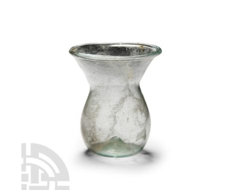 4th century A.D. With dimpled base and funicular neck. Cf. Whitehouse, D., Roman Glass in the Corning Museum of Glass, vol.1,