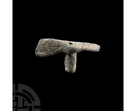 13th-6th century B.C. Composed of a central tubular socket, short adze head with chipped cutting edge and axe head with angle