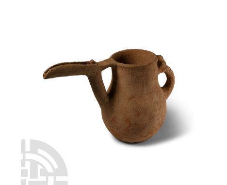 13th-7th century B.C. Piriform-bodied with a broad neck, slender spout with zoomorphic U-section terminal, double looped hand