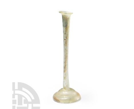 2nd-3rd century A.D. Tall thin translucent pale green vessel with wide base and flared rim. Cf. Whitehouse, D., Roman Glass i