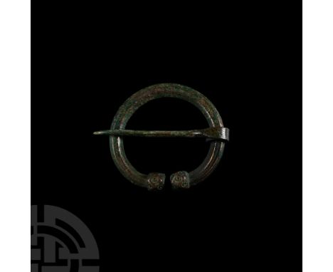 9th-11th century A.D. Composed of a facetted hoop with facetted terminals, stamped ring-and-dot ornament to each face, slende
