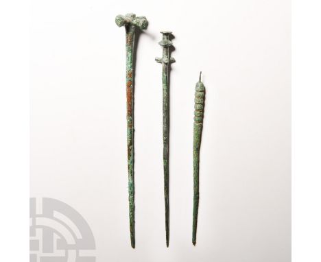 13th-7th century B.C. A trio of pins composed of tapering round-section stems and decorative upper bodies and finials, includ